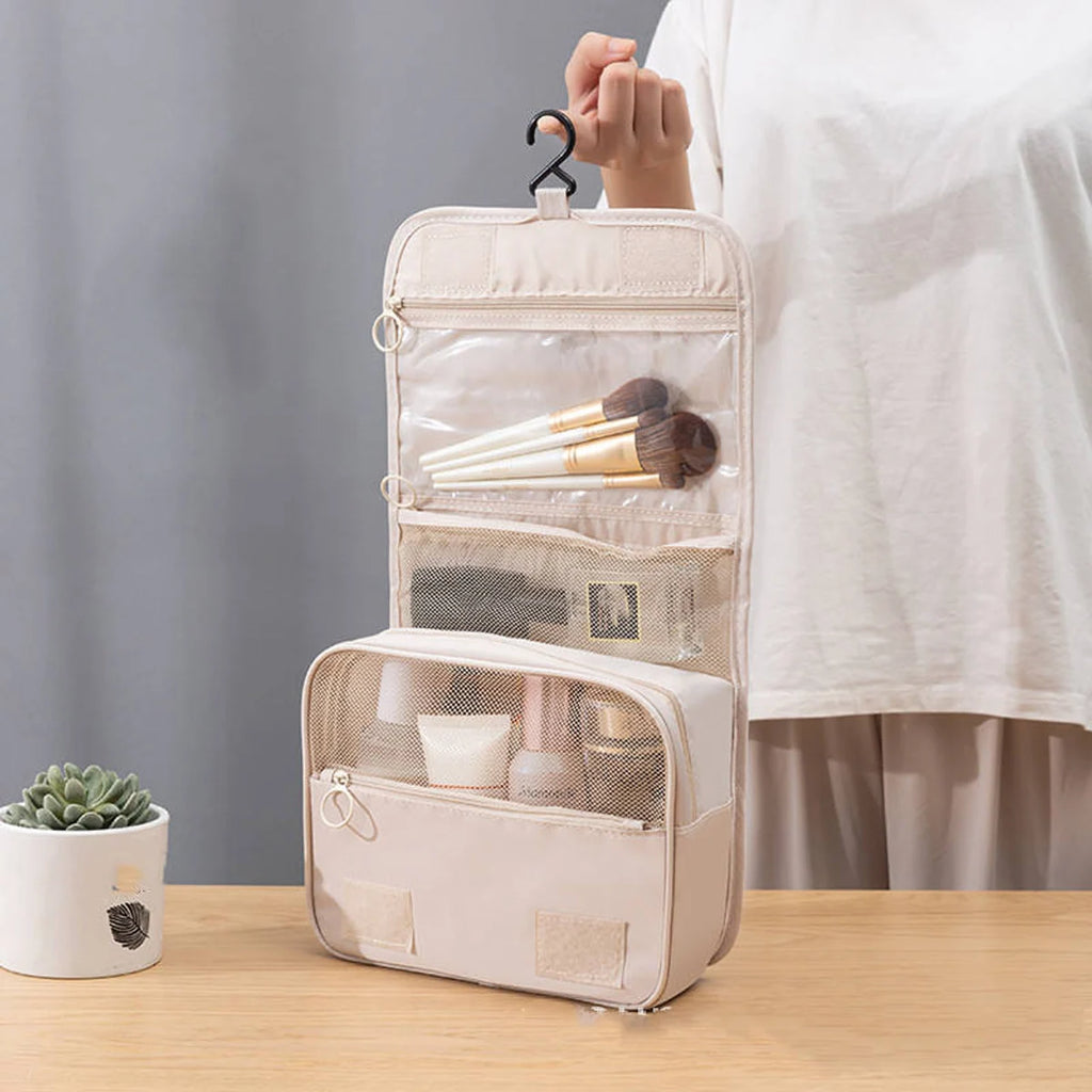 Beige hanging toiletry bag open with toiletries organized inside