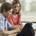 Black tablet cushion stand used for hands-free viewing at a table