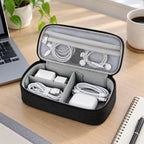 Black cable organizer bag open with chargers arranged on a desk