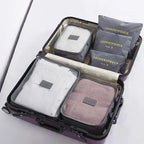 Grey six-piece packing cube set arranged inside an open suitcase