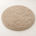 Khaki round plush area rug shown alone on a light background.