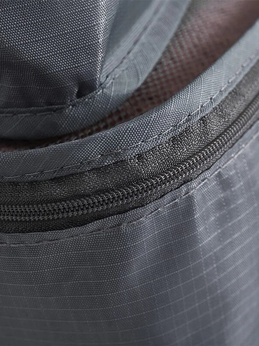 Close view of grey packing cube zipper, stitching and fabric