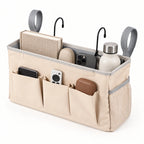Beige bedside caddy organizer showing its main compartment and five accessible storage areas