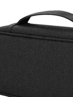 Close view of black woven fabric, carry handle and zipper