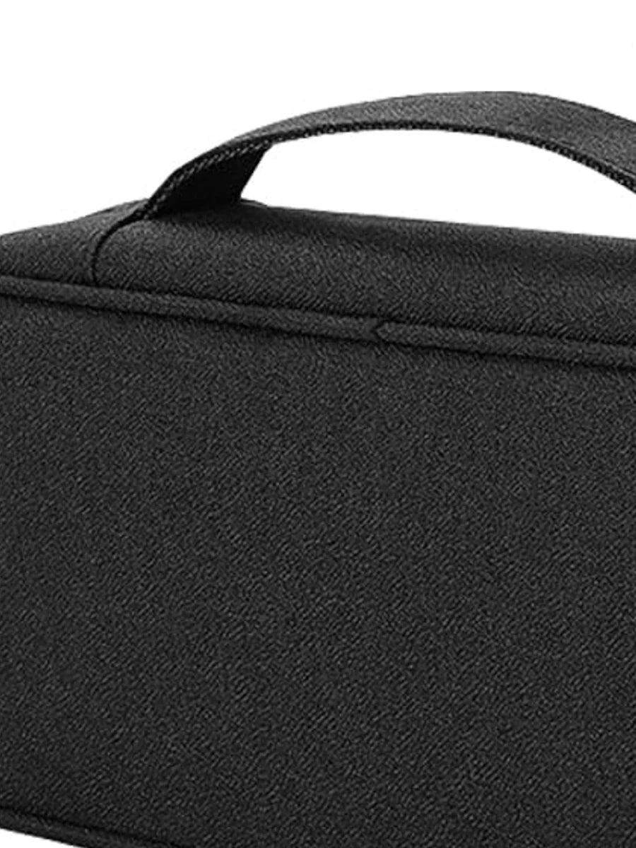 Close view of black woven fabric, carry handle and zipper
