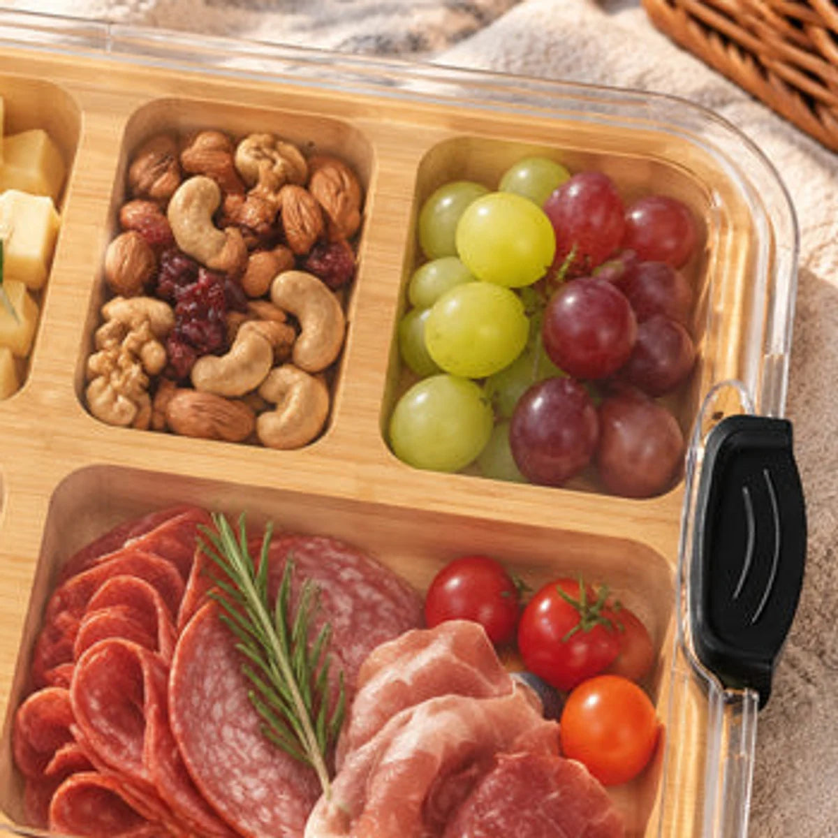 Close view of bamboo compartments, clear lid and locking clip
