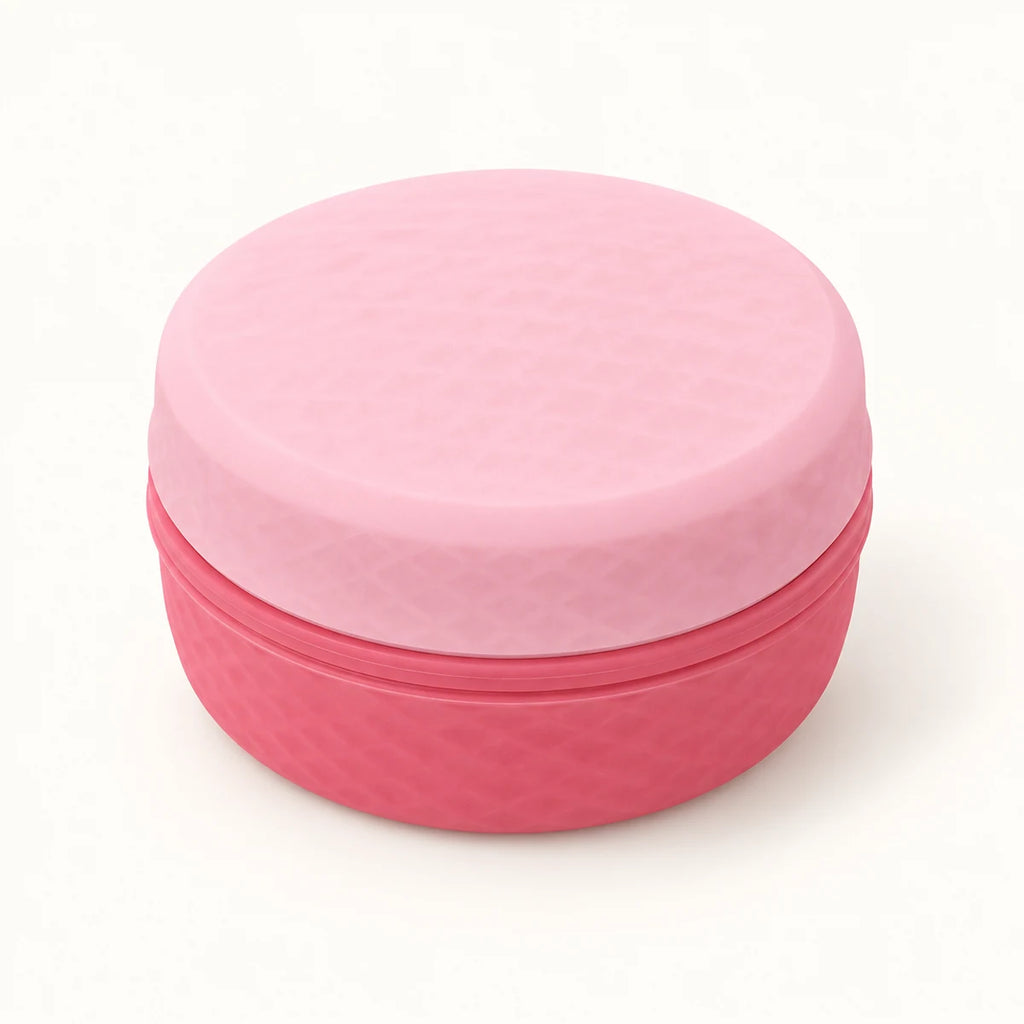 Closed pink cosmetic storage organizer on a warm neutral background