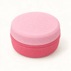 Closed pink cosmetic storage organizer on a warm neutral background