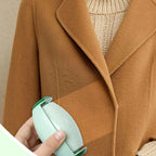 Green reusable lint roller removing lint from a coat