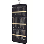 Black hanging jewelry organizer with necklace hooks on white