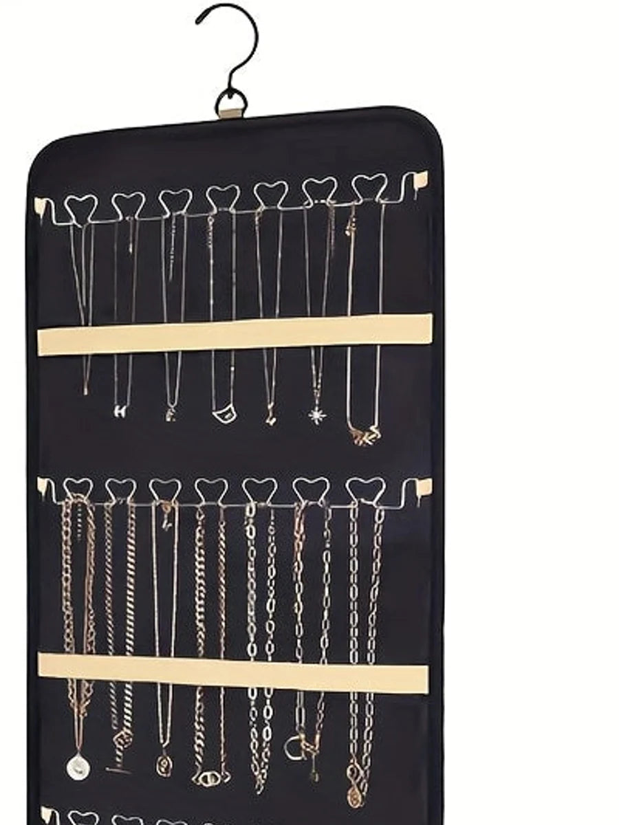 Close view of necklace hooks and retaining straps on a black organizer