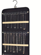 Close view of necklace hooks and retaining straps on a black organizer