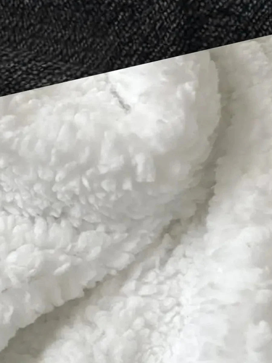 Close view of black plush fabric and white sherpa lining