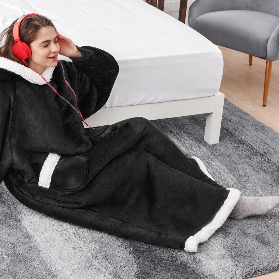 Black oversized wearable blanket hoodie worn in a bedroom