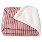 Folded pink ribbed throw blanket with white sherpa reverse
