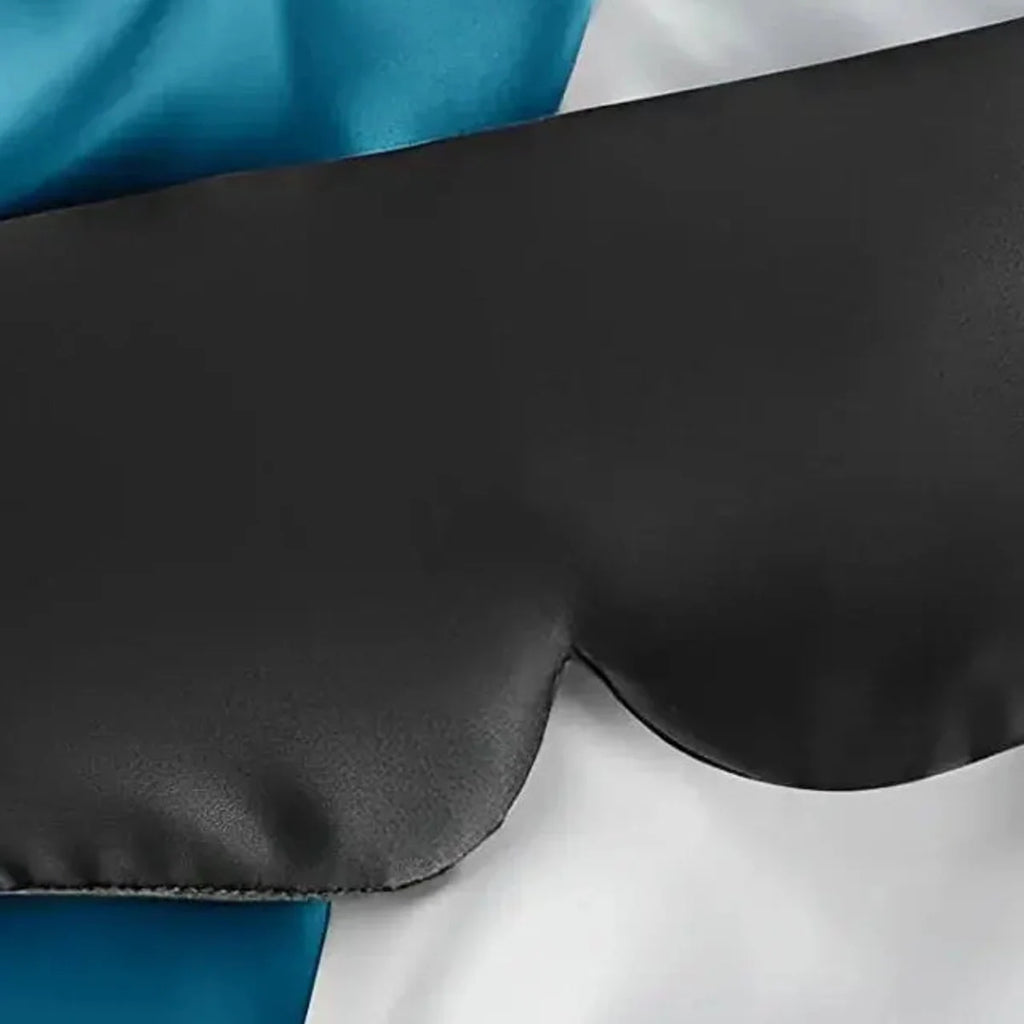 Close view of the black sleep mask satin surface and eye contour