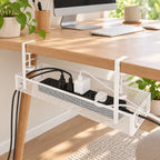 White under-desk cable tray installed below a light wood desk with organized power adapters