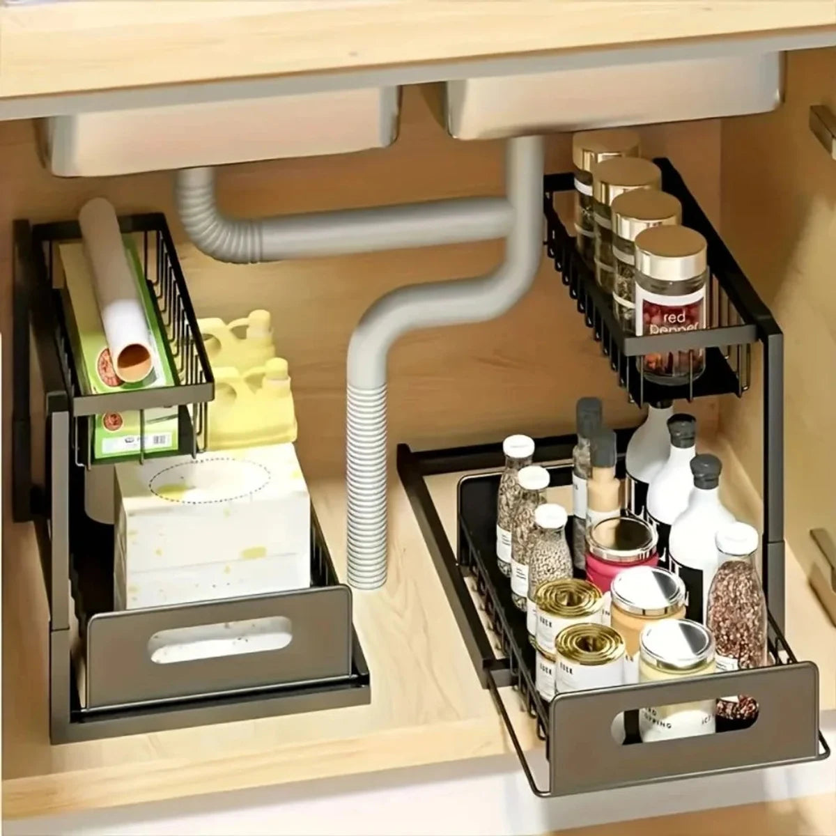 Black under-sink organizers arranged around sink plumbing
