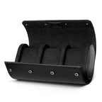 Black three-slot watch travel roll open on a white background