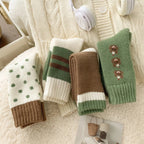 Four pairs of winter socks in green, cream and brown patterns