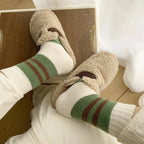 Green striped pair from the four-pair winter sock set worn with slippers