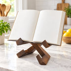 Dark wood cookbook stand holding an open recipe book on a warm kitchen counter