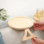 Round wooden sofa arm tray being fitted onto a couch arm